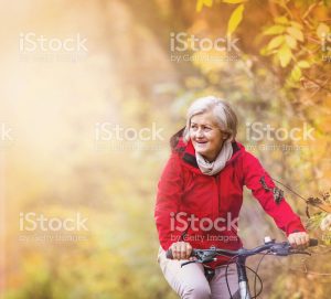 Senior woman cycling without glasses